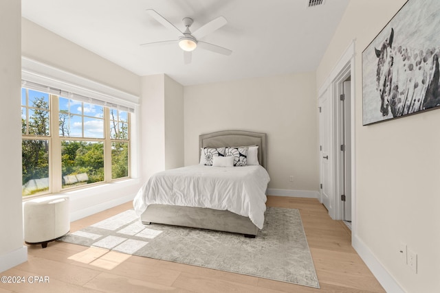 bedroom featuring light hardwood / wood-style floors and ceiling fan