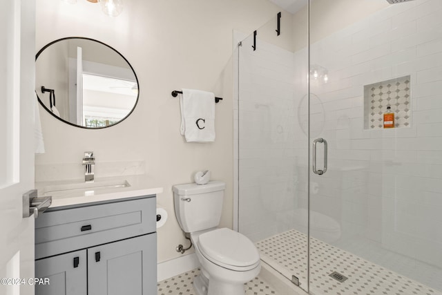 bathroom with toilet, vanity, and walk in shower