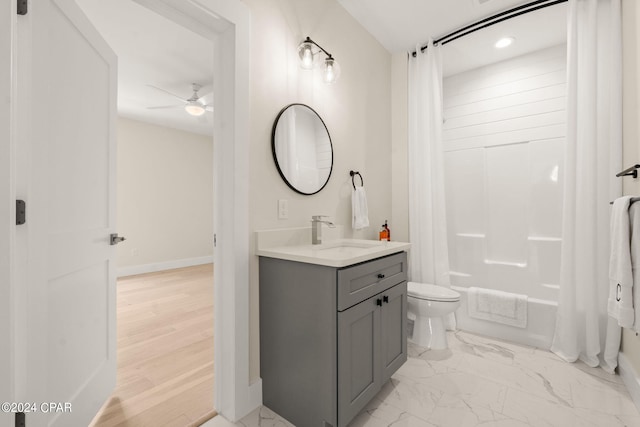 full bathroom with ceiling fan, vanity, shower / tub combo, and toilet