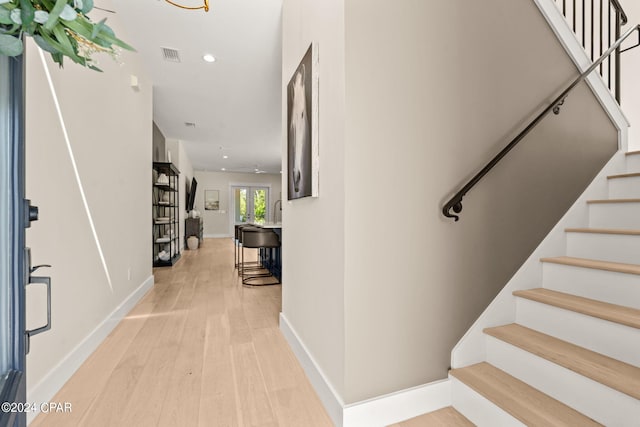 stairs with hardwood / wood-style floors