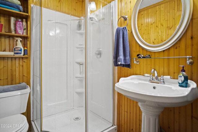 13272 NW State Road 20, Bristol, FL 32321 - bathroom featuring wood walls, a stall shower, and toilet