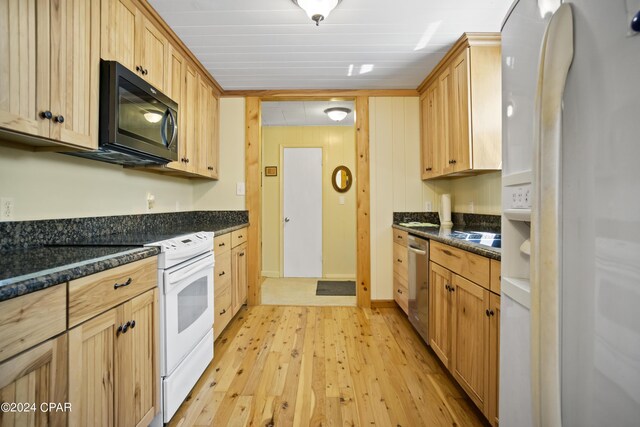 13272 NW State Road 20, Bristol, FL 32321 - kitchen with white refrigerator with ice dispenser, stainless steel dishwasher, light wood-type flooring, a sink, and dark stone counters