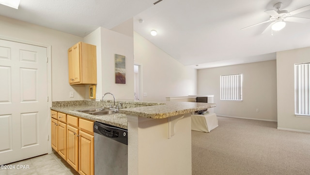 kitchen featuring a kitchen breakfast bar, kitchen peninsula, light colored carpet, and stainless steel dishwasher