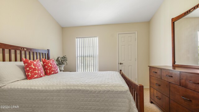 carpeted bedroom featuring vaulted ceiling