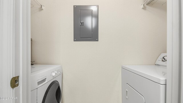 washroom featuring electric panel and washer and dryer