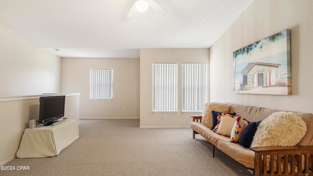 carpeted living room with ceiling fan