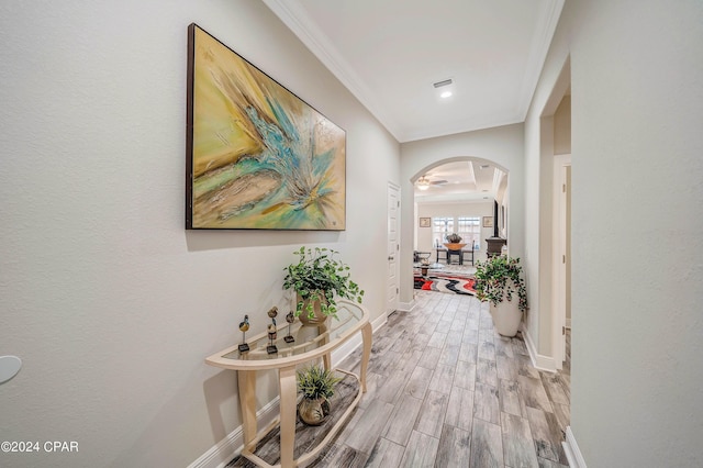 corridor featuring light hardwood / wood-style floors and crown molding