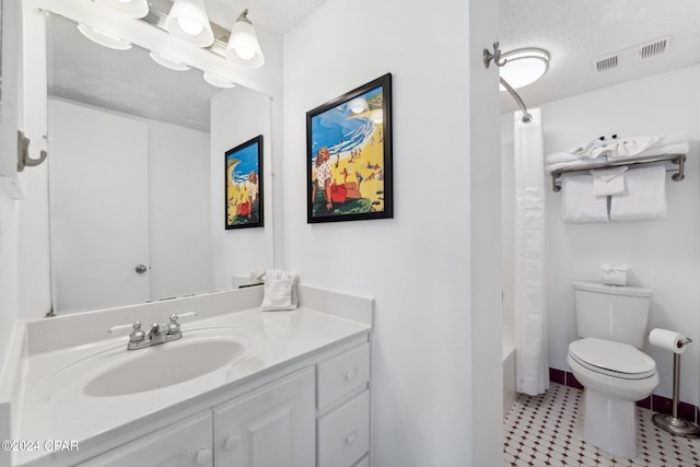 full bathroom with vanity, a textured ceiling, shower / bath combo with shower curtain, tile patterned floors, and toilet