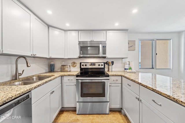 23223 Front Beach Rd Ph 4, Panama City Beach, FL 32413 - kitchen with stainless steel appliances, a sink, tasteful backsplash, light stone countertops, and recessed lighting