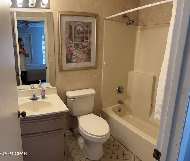 full bath featuring bathing tub / shower combination, toilet, vanity, ensuite bath, and tile patterned floors