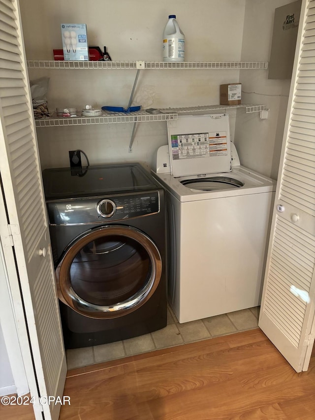 washroom featuring light wood-style floors, washer and dryer, and laundry area