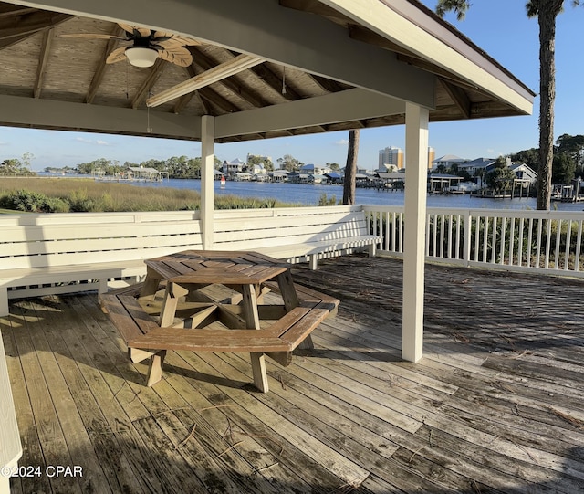 view of dock featuring a deck with water view and a gazebo