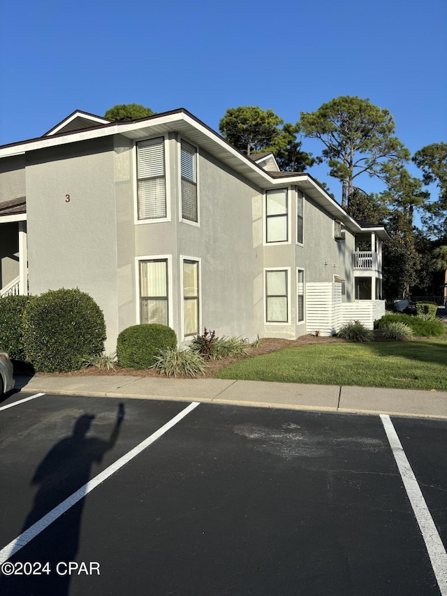 view of property with uncovered parking