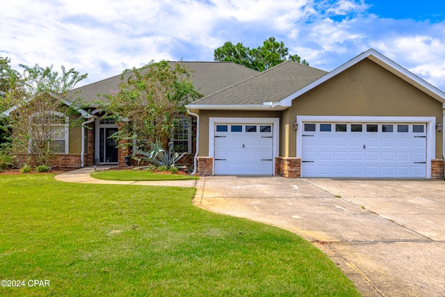 view of front of house with a garage and a front yard