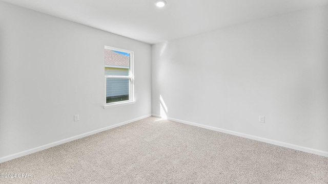 empty room with carpet flooring and baseboards