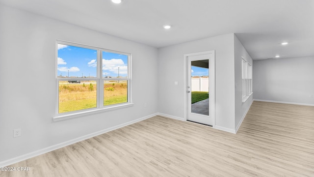 spare room with light wood-style floors, recessed lighting, and baseboards