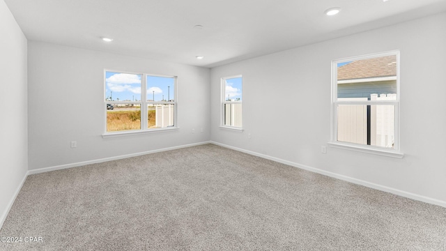 unfurnished room with recessed lighting, carpet, and baseboards