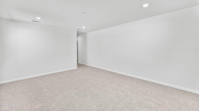 empty room with light colored carpet, visible vents, and recessed lighting