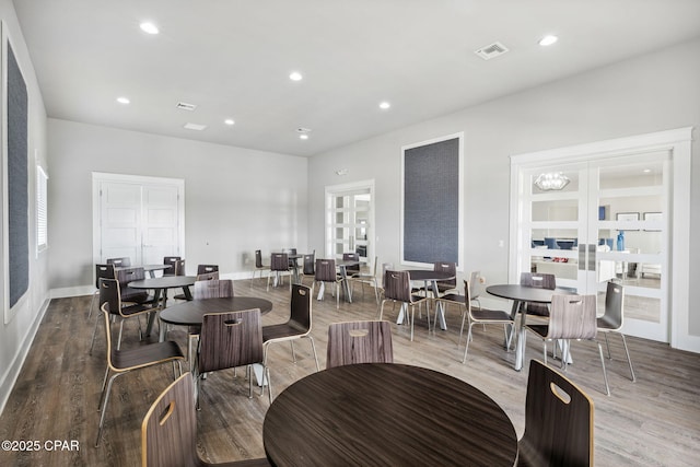 dining area featuring baseboards, visible vents, wood finished floors, french doors, and recessed lighting