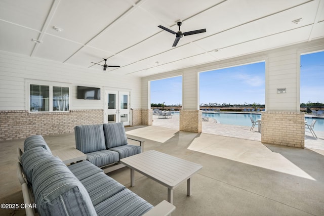 view of patio / terrace featuring a community pool, an outdoor living space, a ceiling fan, and french doors