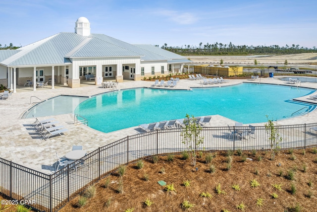 community pool featuring a patio area and fence