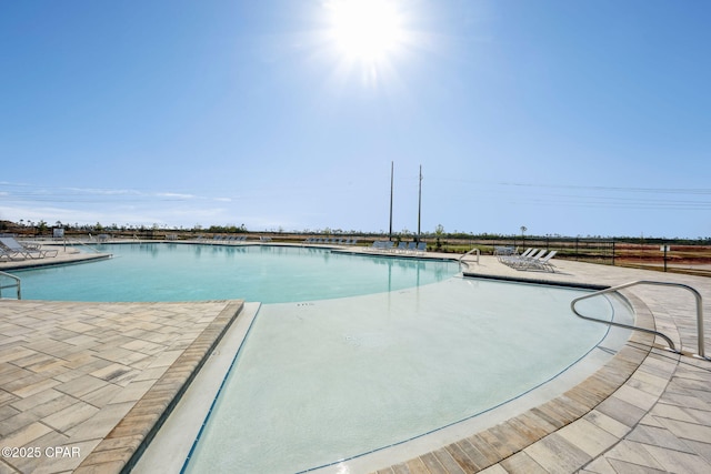 community pool with a patio area