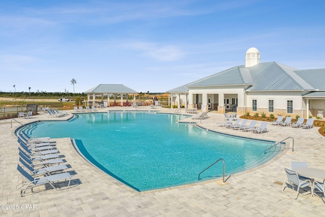 pool featuring fence, a patio, and a gazebo