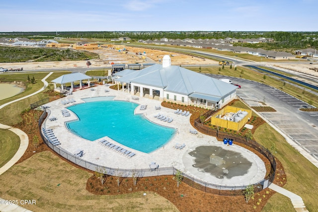 community pool with a patio, a gazebo, and fence