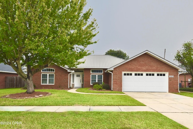 ranch-style house featuring a front lawn and a garage