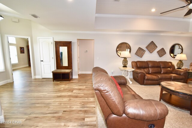 living room with light wood-type flooring, crown molding, and ceiling fan