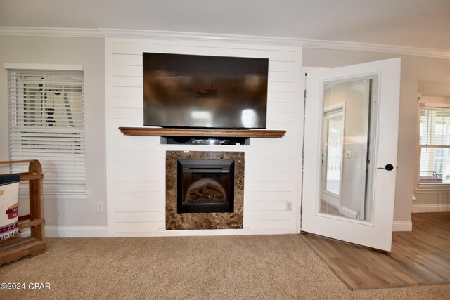 unfurnished living room with carpet flooring and ornamental molding