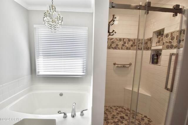 bathroom featuring an inviting chandelier, crown molding, and separate shower and tub