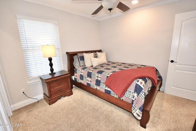 bedroom with ornamental molding, ceiling fan, and light colored carpet