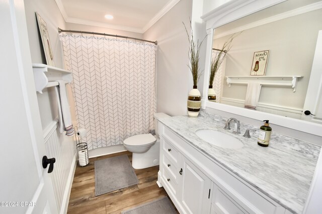 bathroom featuring crown molding, hardwood / wood-style flooring, vanity, and toilet