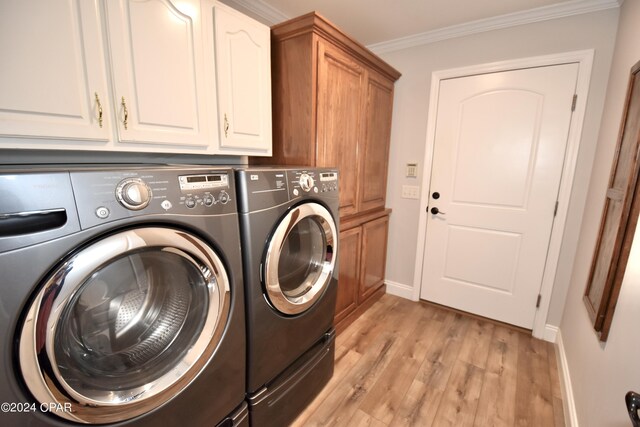 laundry room with cabinets, light wood-type flooring, independent washer and dryer, and crown molding