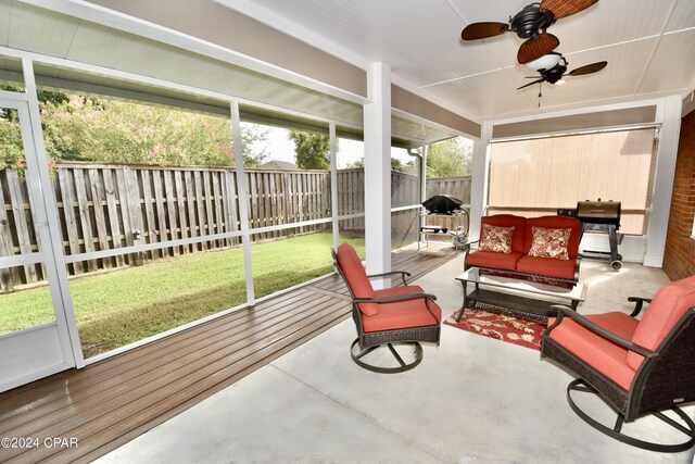 sunroom / solarium featuring ceiling fan