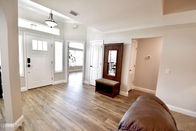 foyer featuring light hardwood / wood-style flooring and ornamental molding