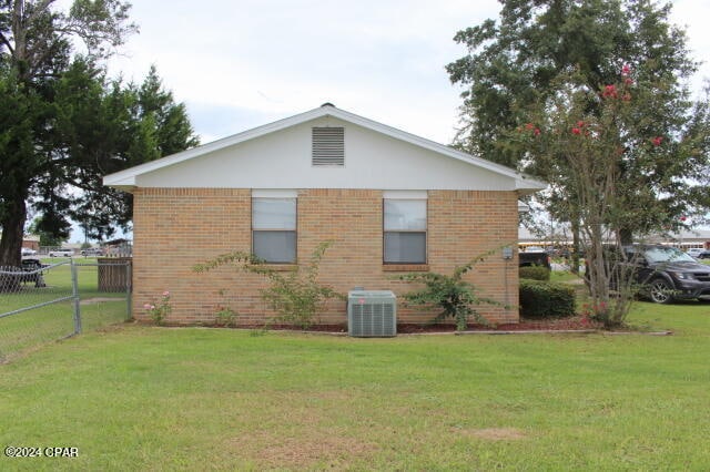 view of home's exterior featuring a lawn and central air condition unit