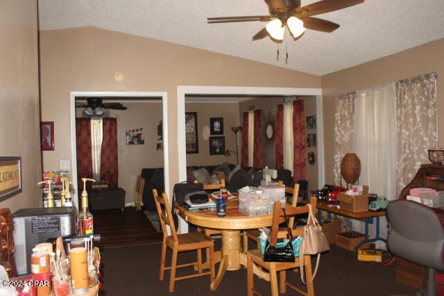 dining room with ceiling fan, a textured ceiling, and vaulted ceiling