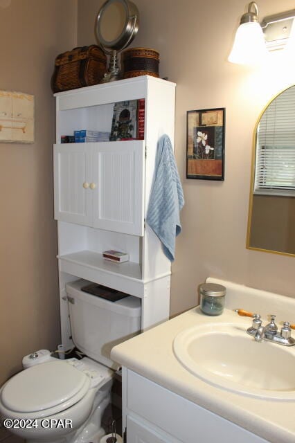 bathroom featuring vanity and toilet