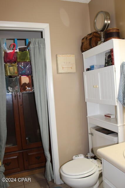 bathroom featuring vanity, toilet, and tile patterned floors