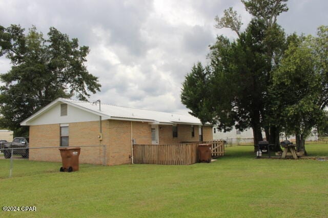 exterior space with a deck and a yard