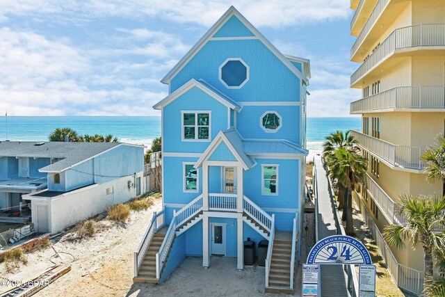 view of front of house with a water view