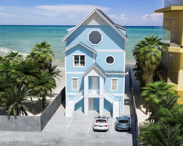 view of front of home featuring stairway and a water view