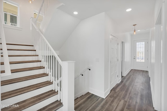 staircase featuring recessed lighting, baseboards, and wood finished floors