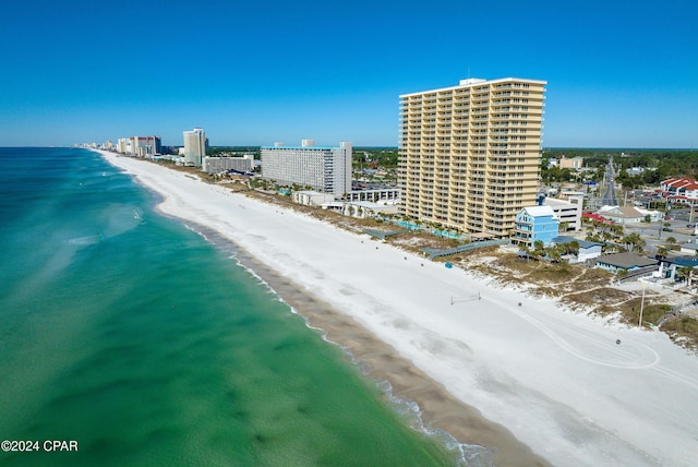 bird's eye view featuring a water view, a city view, and a beach view