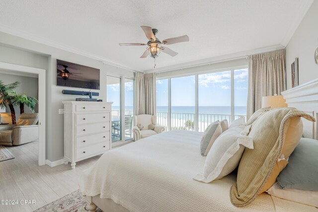 bedroom featuring ceiling fan, multiple windows, light wood-type flooring, and access to outside