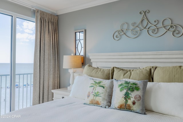 bedroom featuring a water view, access to exterior, multiple windows, and crown molding