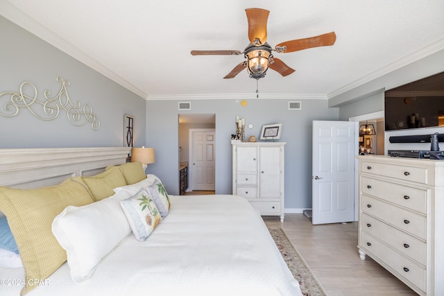 bedroom featuring ornamental molding, ceiling fan, and light hardwood / wood-style flooring