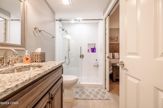 bathroom with a stall shower, toilet, tile patterned floors, ensuite bathroom, and vanity